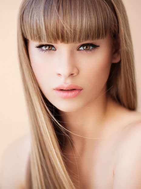 Outdoor shot of young beautiful woman. Professional make up and hair style.